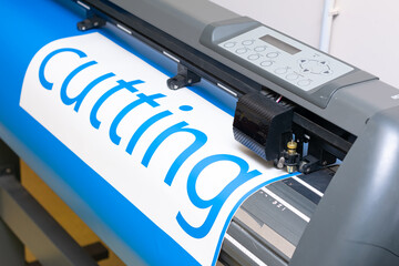 Cutting plotter close-up. The process of cutting a vinyl film.