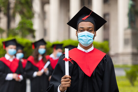 Black Guy Student In Graduation Dress, Wearing Face Mask