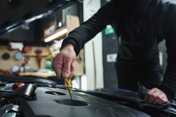 Man doing car maintenance at inspection station