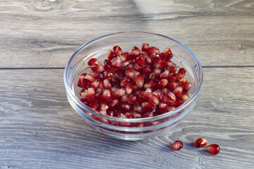 Juicy ripe pomegranate grains. Concept of vegan dessert.