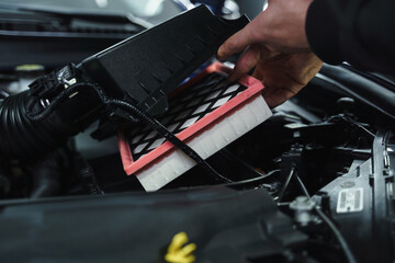 Obraz premium Man doing car maintenance at inspection station