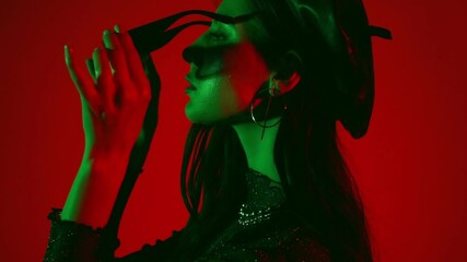 Side view of young model wearing sunglasses isolated on red - Powered by Adobe