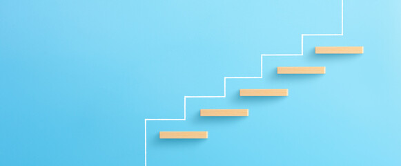 Ladder of success in business growth concept, Wooden block stacking as step stair on blue background, copy space