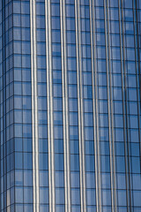 A modern skyscraper for office work. Glass surface of windows, a large amount of light,