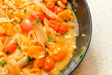 Red cherry tomatoes sauteed with onions shallot and garlic