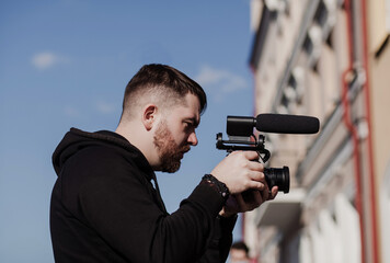 bearded cameraman with a camera