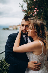 A romantic walk for the bride and groom along the shores of an Italian lake. It's a nasty day.