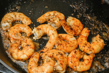 Shrimp buttered in a cast iron skillet