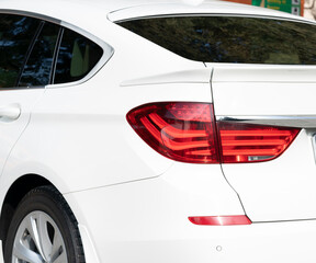 Rear headlight white car close-up stop signal.