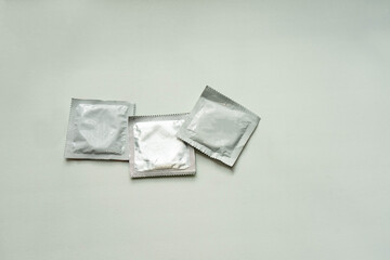Condom packaging. Three condoms on a white background.
