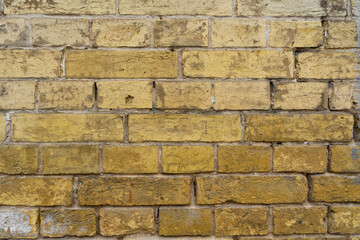 old yellow brick wall – close-up background of the. Ancient Yellow brick wall background.