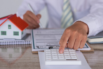  Attention to property services and insurance concept.Sales manager or real estate agent will be prepared to show you a sample home and detail the terms of buying a home with insurance promotions,