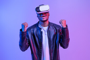 Overjoyed Black Man In VR Glasses And Leather Jacket Playing Video Games