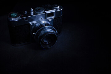 Old vintage camera closeup on darken background