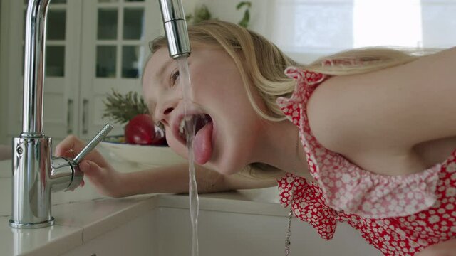 Girl tries drink tap water