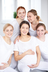 Portrait Of Young Mixed Race Pregnant Women In Sportswear Posing At Camera In Fitness Studio