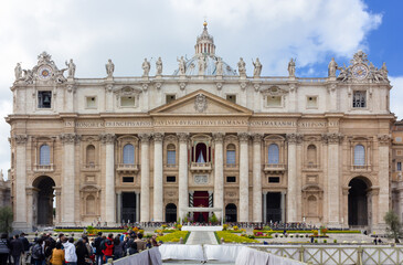 Main facade of the Basilica of Saint Peter in the Vatican in Rome, crowded with people