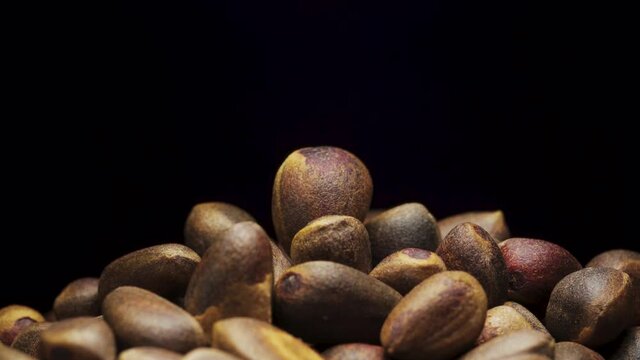 A handful of pine nuts. Spinning pine nut at the top. Close-up.