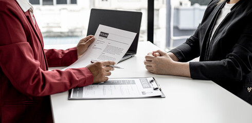 The manager is interviewing job applicants and reading the candidate's personal information on the...