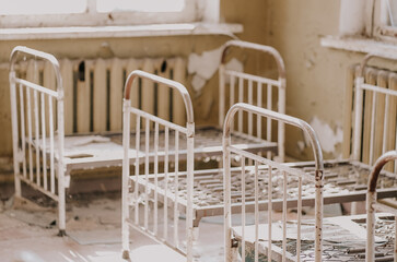 Fototapeta na wymiar Chernobyl Exclusion Zone, Ukraine Bedroom of an abandoned kindergarten