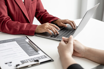 The HR department is typing a laptop to fill out the applicant's information after being interviewed by the department manager and accepting jobs for the job applicant. Job application ideas