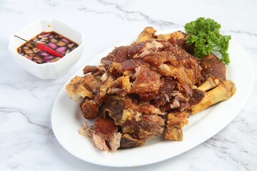 Freshly cooked Filipino food called Crispy Pata or deep fried crispy pork leg
