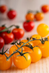 Red and yellow cherry tomatoes on wood