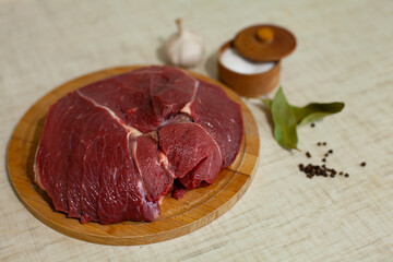 Large horizontal photo. Healthy eating. Fresh red beef meat on a wooden board. Beef pulp with spices. Homemade food. Cooking meat dishes. ECO. Farm product.