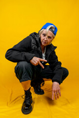 Funny portrait of mature woman. Lady having fun dressed as an angry rapper