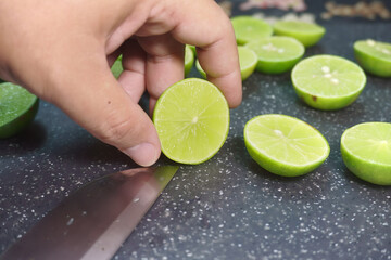 image of hand a cut lemon grip