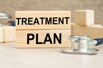 TREATMENT PLAN information written on wooden bars. Medical concept