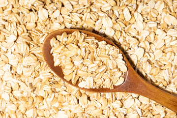 Avena Sativa is scientific name of Oat cereal grain. Also known as Aveia or Avena. Healthy grains on a wooden spoon