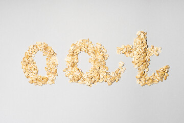 Word OAT made of flakes on grey background