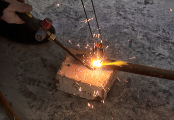 worker cutting steel pipe using metal torch