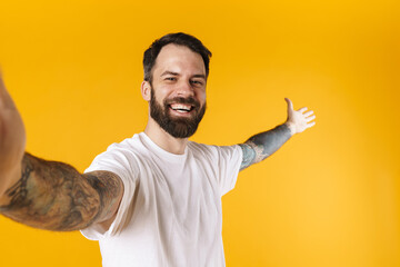 Fototapeta premium Portrait of a happy brunette bearded man standing