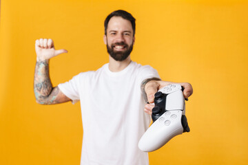Happy mid aged brunette bearded man holding joystick © Drobot Dean