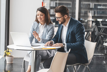 Office workers discuss new company projects.They sit at the desk in the company cafe  and prepare...