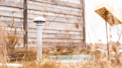 The tube brought out for air extraction and ventilation of the sewerage room and the water pumping station of a private house