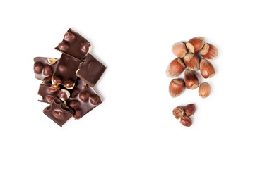 flat lay of pieces of dark chocolate with whole nuts. isolated on the white background