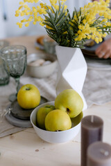 Green apples on a saucer Kitchen table in the house Beautiful decor