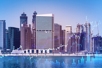 Fototapeta premium Skyscrapers of Dubai business downtown. International hub of trading and financial services of Western Asia. FOREX graph and chart concept. Double exposure. Dubai Canal waterfront.