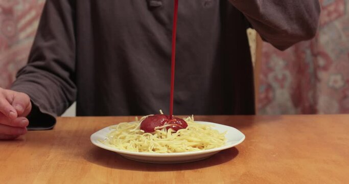 Covering spaghetti in huge amounts of ketchup