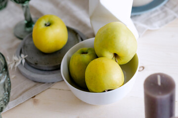 Green apples on a saucer Kitchen table in the house Beautiful decor