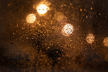 Blurred background with raindrops and lights.