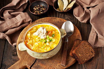 Sauerkraut soup in ceramic bowl on wooden table