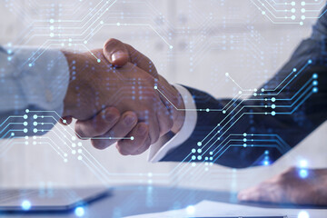 Handshake of two businessmen who enters into the contract to develop a new software to improve business service at a company. Technological icons over the table with the document.
