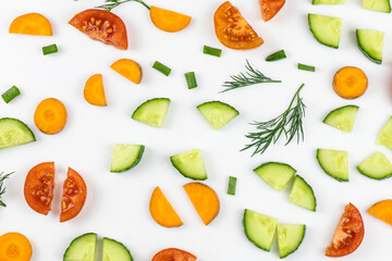 The vegetables cut by pieces are isolated on a white background.