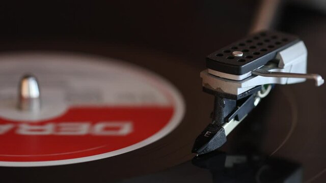 Record needle on a vinyl record. The record is experiencing a rebirth these years. Many change again and enjoy the crackle and pop. Detail.