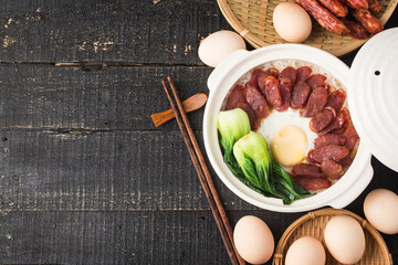 Cantonese style cooking of claypot rice with waxed meats