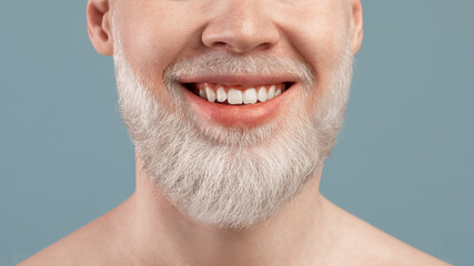 Obraz premium Cropped portrait of albino man with wide beaming smile and healthy teeth, over turquoise studio background, closeup